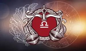 Symbol Wagi, rodonit znak zodiaku, otoczony kryształami i kołem zodiaku.