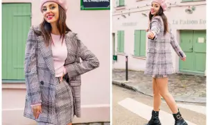 Dziewczyna w różowym beretce i kraciastej marynarce w stylu preppy, z mini spódniczką i botkami, pozuje na tle paryskiej uliczki.