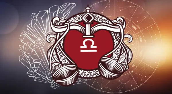 Symbol Wagi, rodonit znak zodiaku, otoczony kryształami i kołem zodiaku.