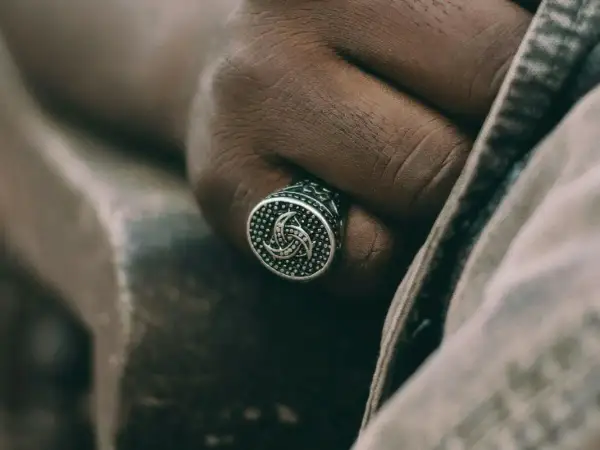 Męska dłoń z sygnetem w kształcie potrójnego rogu Odyna. Co to za symbol?